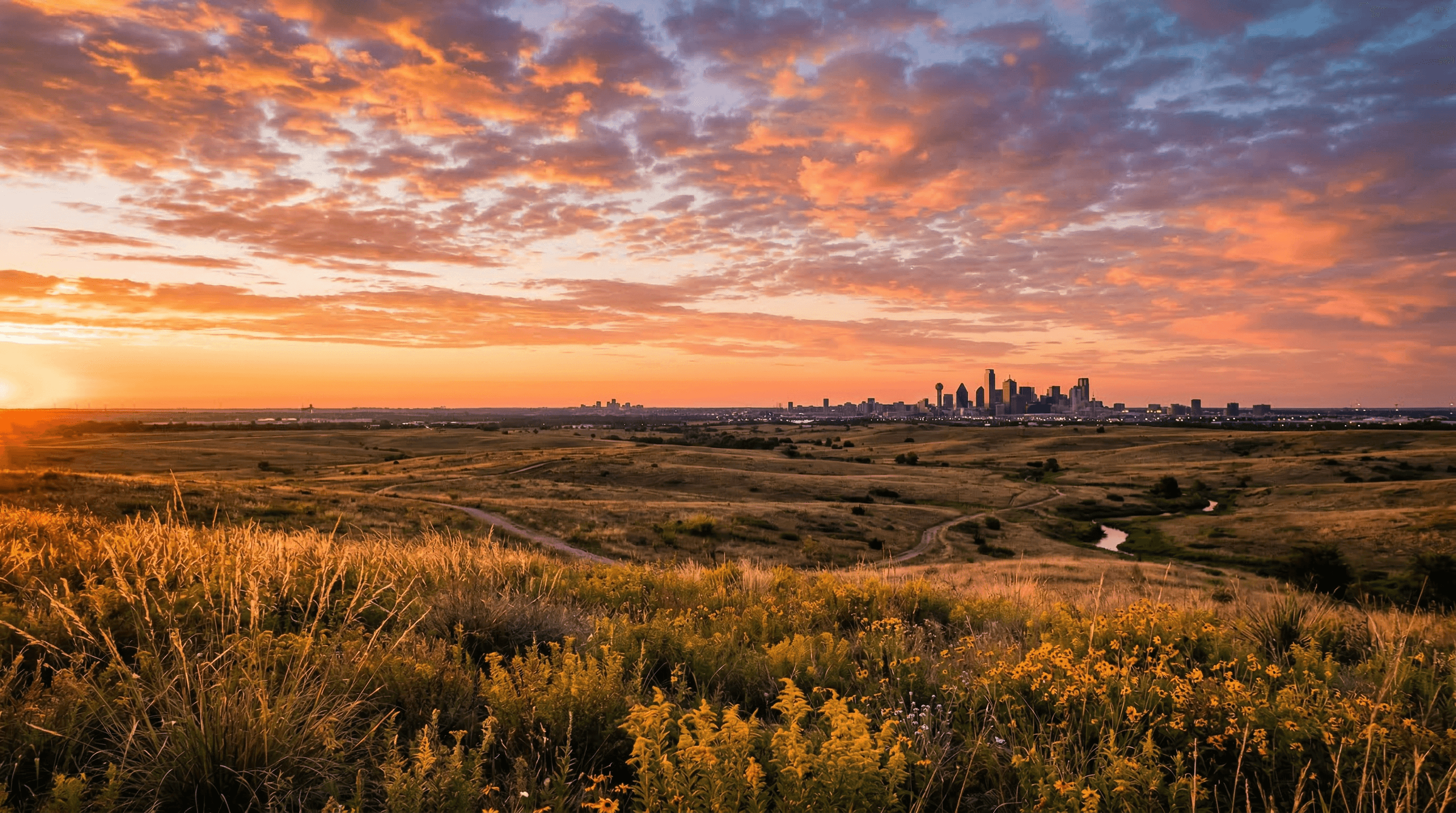 North Texas prairie at sunset with the Dallas-Fort Worth skyline on the horizon
